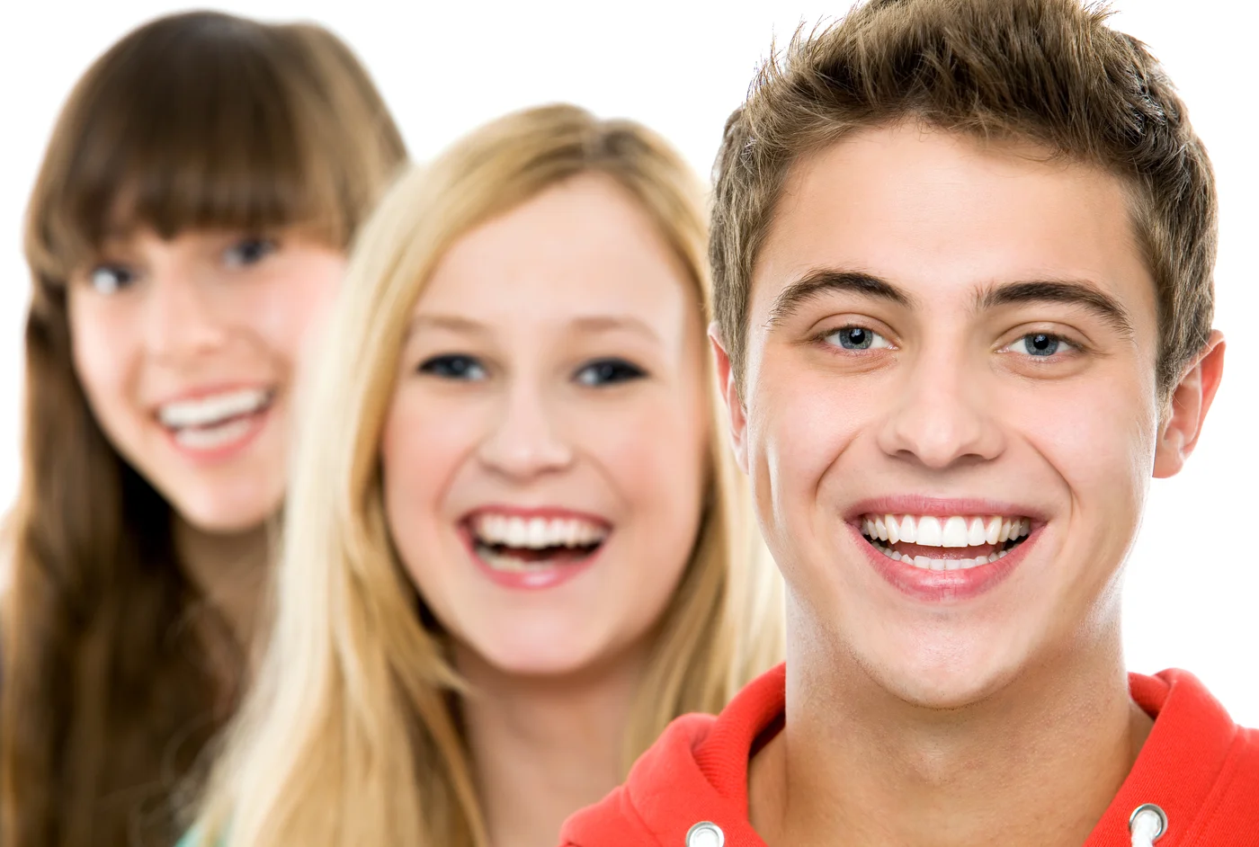 Young man with braces smiling with two friends