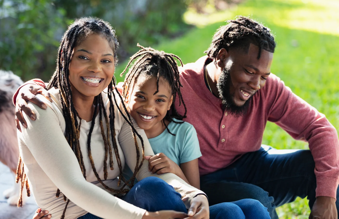 Family smiling together outdoors